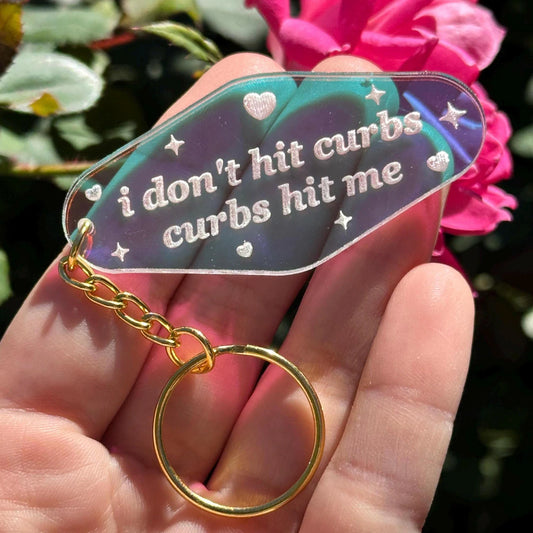 I Don’t Hit Curbs, Curbs Hit Me Iridescent Acrylic Motel Keychain